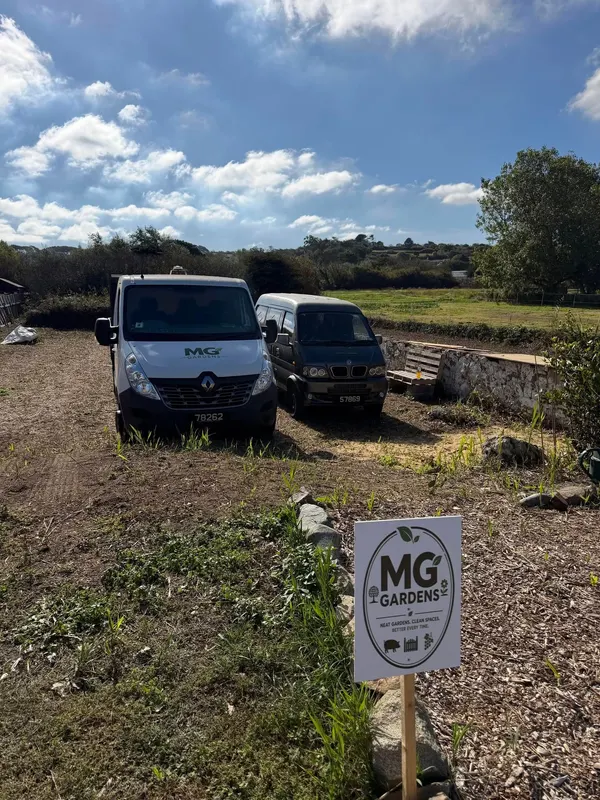 MG Gardens vans parked on a large garden being cleared